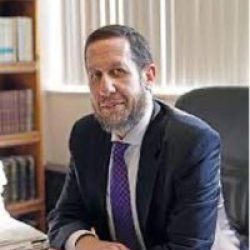 Rabbi Yitzchak Schochet Sitting at Desk